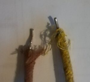 Two frayed electrical cables, beige and yellow.