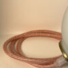 Copper braided cable on white background.