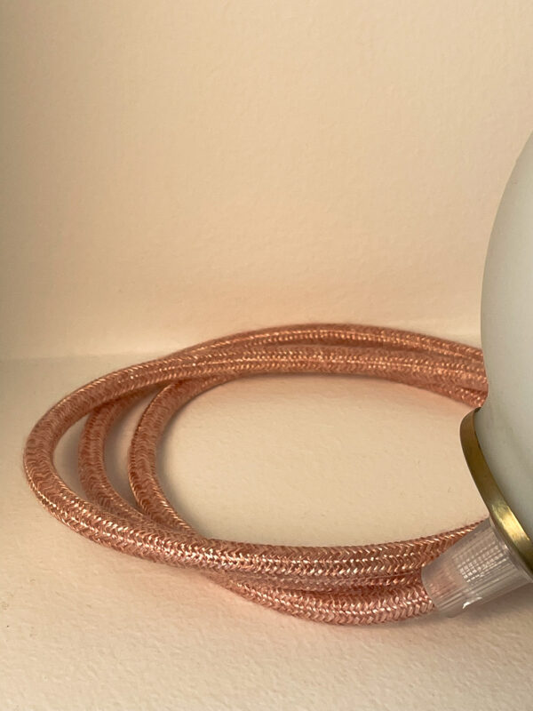 Copper braided cable on white background.