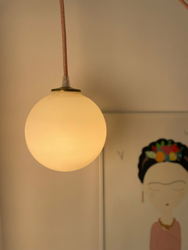 Hanging pendant light with warm glow.