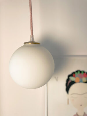 Frosted globe pendant light with artwork.