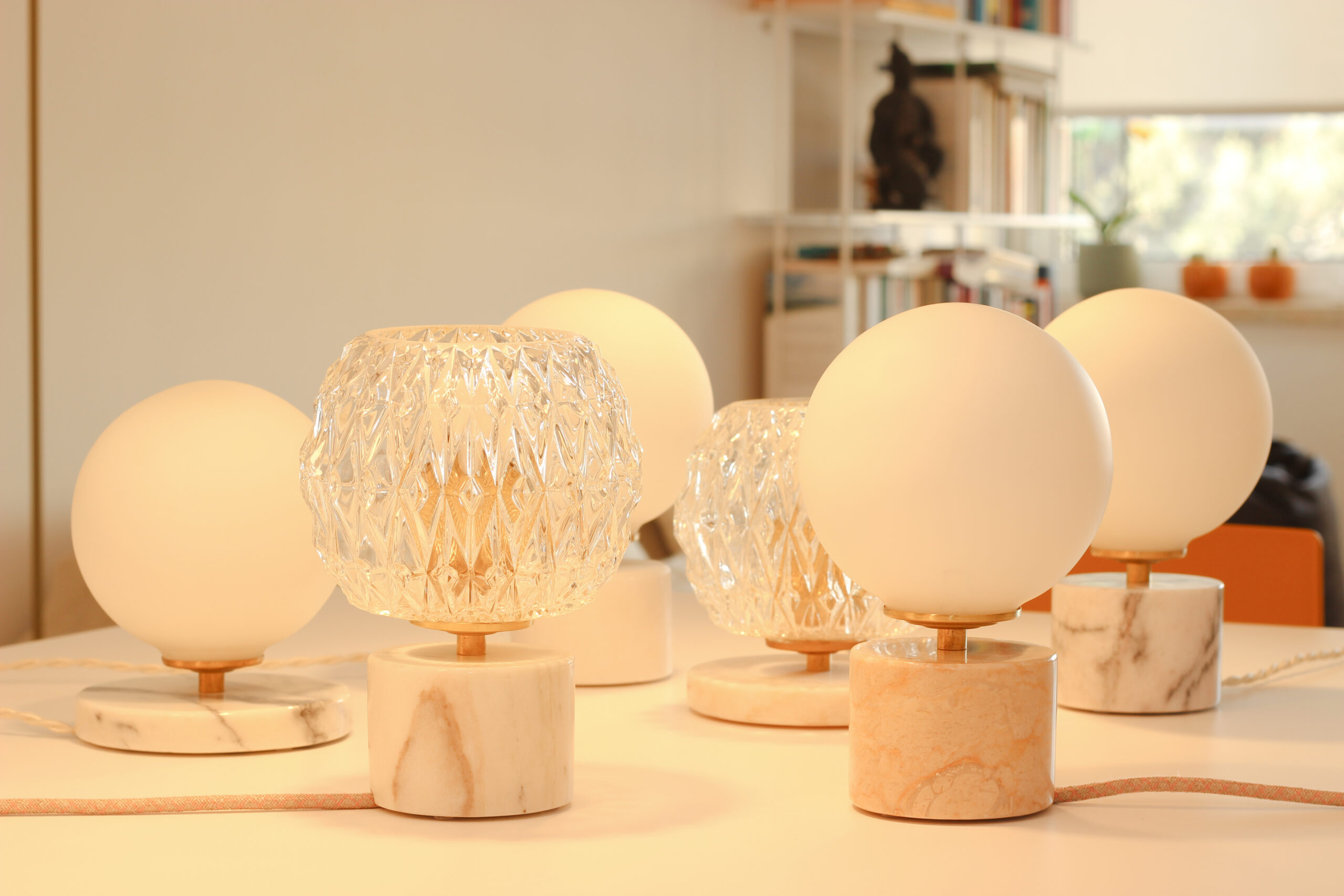 Designer table lamps with a marble base and a glass globe.