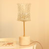 Vintage table lamp composed of a chiseled glass globe and a white marble base with beige veins.
