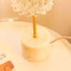 Vintage table lamp composed of a chiseled glass globe and a white marble base with beige veins.