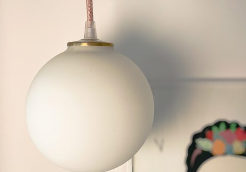 Frosted globe pendant light with artwork.